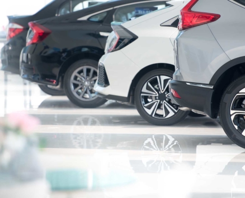 new vehicles on shiny car dealership flooring